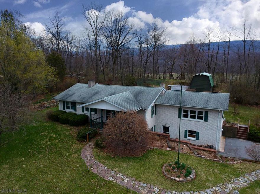 Fantastic views from this solid brick ranch home on nearly 3.5 acres. Oversize addition with vaulted ceilings and a sunroom mean this rancher has extra room for you. Master bedroom with master bath. House heats with multi fuel types and woodburning stove makes for cozy heating.  Finished area in the basement for office and workshop. Oversized carport could be used to park an RV. Eat in kitchen and formal dining room. Integral garage and even a greenhouse and oversized shed.