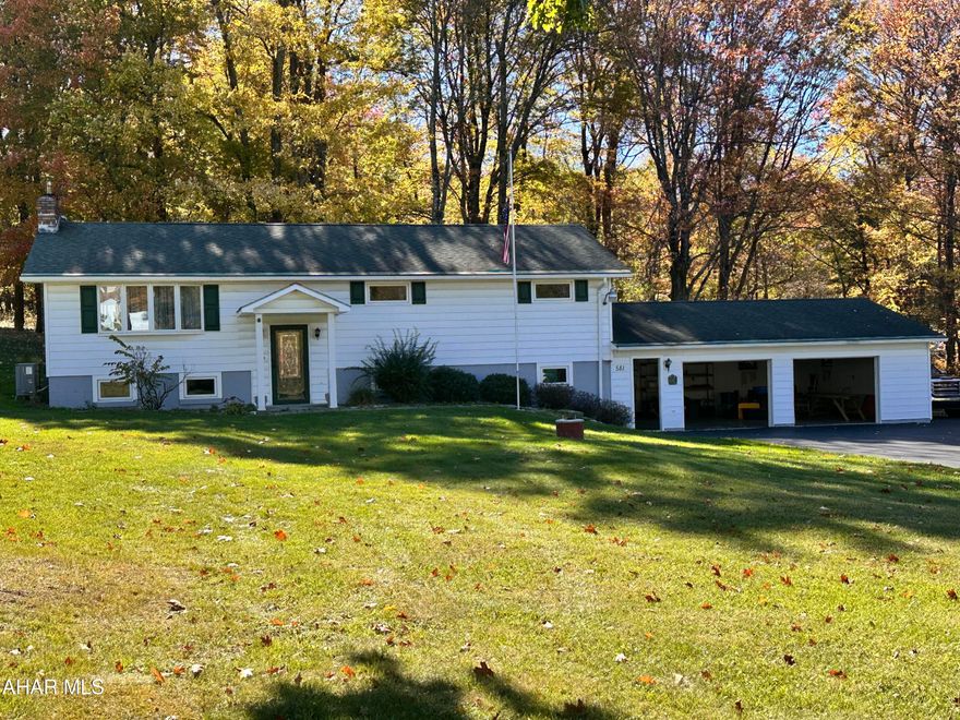 Beautiful split entry home with 2 car garage in a great setting! Recently remodeled kitchen with stainless appliances, first floor updated flooring,  modern bath and below grade 3/4 bath , family room with coal stove and workshop area. Heat sources include an heat pump, and coal and oil furnace. Enjoy nature from the patio or enclosed porch in the rear.