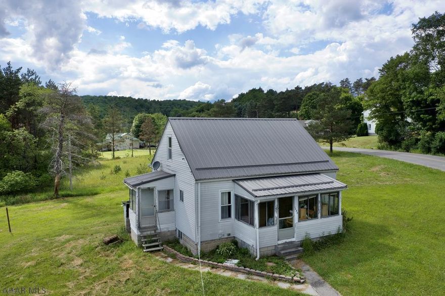 Quaint country home on over 3.5 acres! Newer metal roof! Third bedroom is currently used as a walk-in closet, could potentially be used as small nursery, and or office! One car detached garage, with shed for plenty of storage space. Conveniently located minutes from Saint Francis University!  Approx plot lines are in blue on map under images.