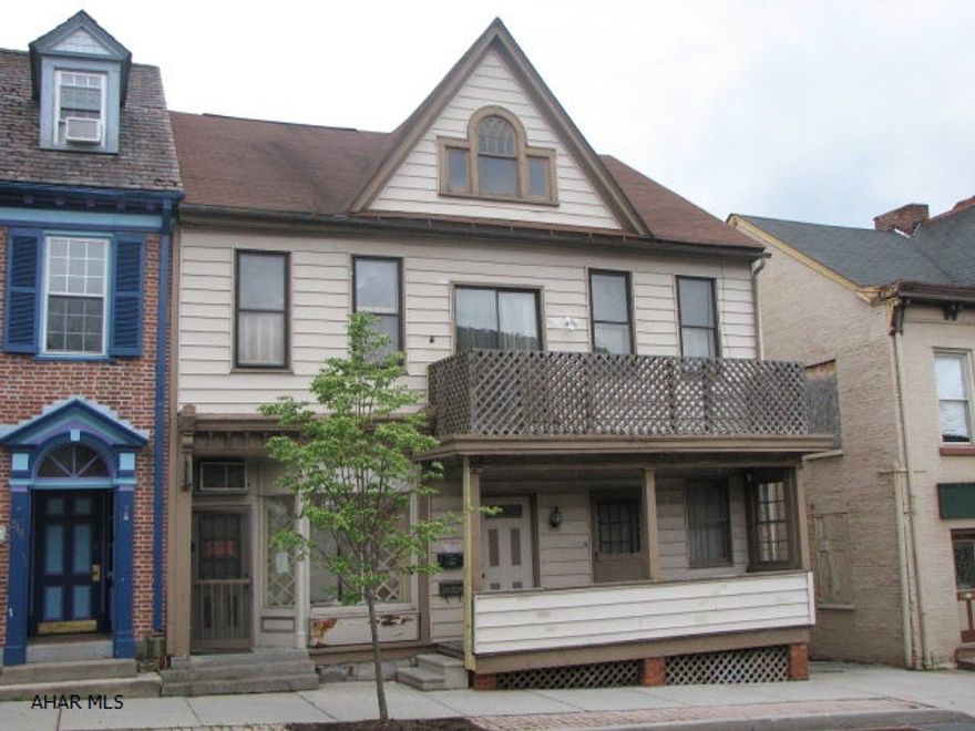 1 store front area plus 2 apts. Property being sold As Is. The alley/driveway to the the right of the property is included except for approx. 2'.