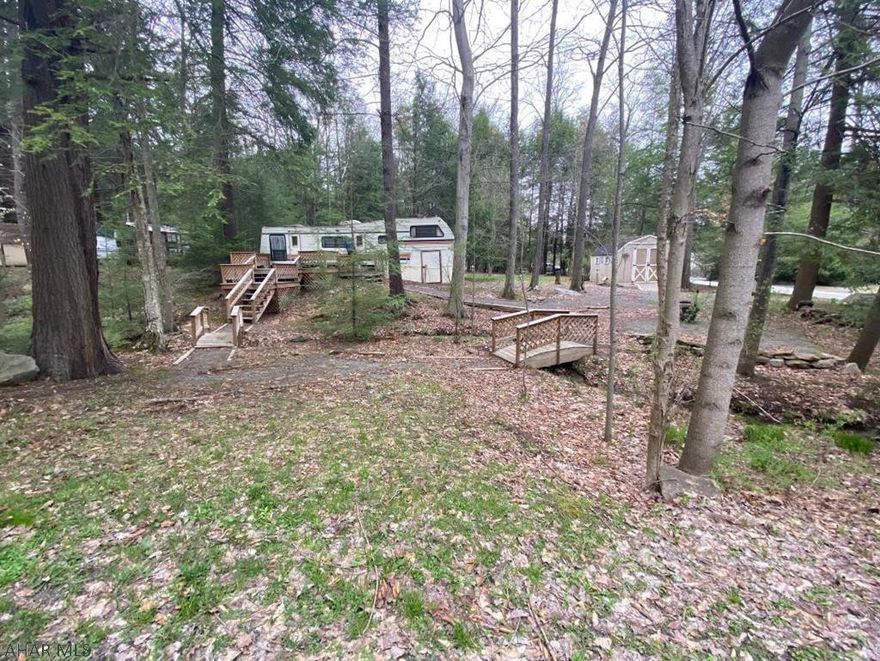 Serene wooded  setting with a stream running through it. This is the perfect setting! 2 lots deeded separately being sold together with a camper and shed.  Lot 102 is 0.13 of an acre and Lot 106 is 0.1. Located in Glendale Yearound, a gated community adjacent to Prince Gallitzin State Park/Glendale Lake and six miles from Rock Run ATV Park.