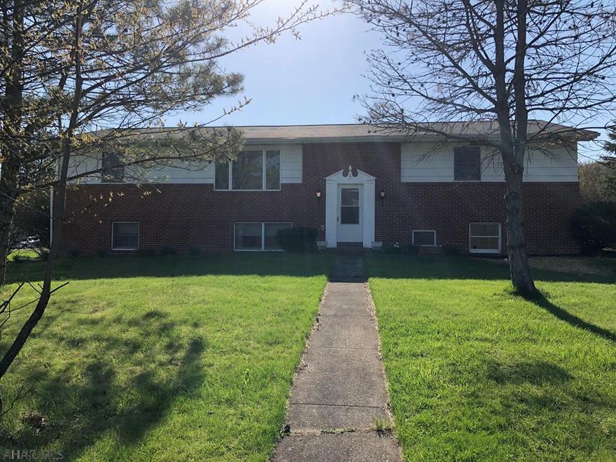 This 4+ bedroom home sits on a 0.5 acre lot in the Hollidaysburg School District. There is approximately 3300 sq ft of living space in this home. The main floor has a living room, open dining area, and kitchen. The cabinets are freshly painted and have new hardware, and the flooring is vinyl. There are 4 bedrooms on this floor and a full bath with double sinks. The master bedroom has a small 3/4 bath. The lower level has a large family room with new ceiling tiles and lights. This level has a bonus room that could be an office. There are 3 other rooms that could be used has bedrooms. All have windows and closets. There is a newly renovated 3/4 bath and laundry room plus an additional room that was used as a pantry. This room has an electric outlet for a stove. 2 car garage,covered patio,AC.
