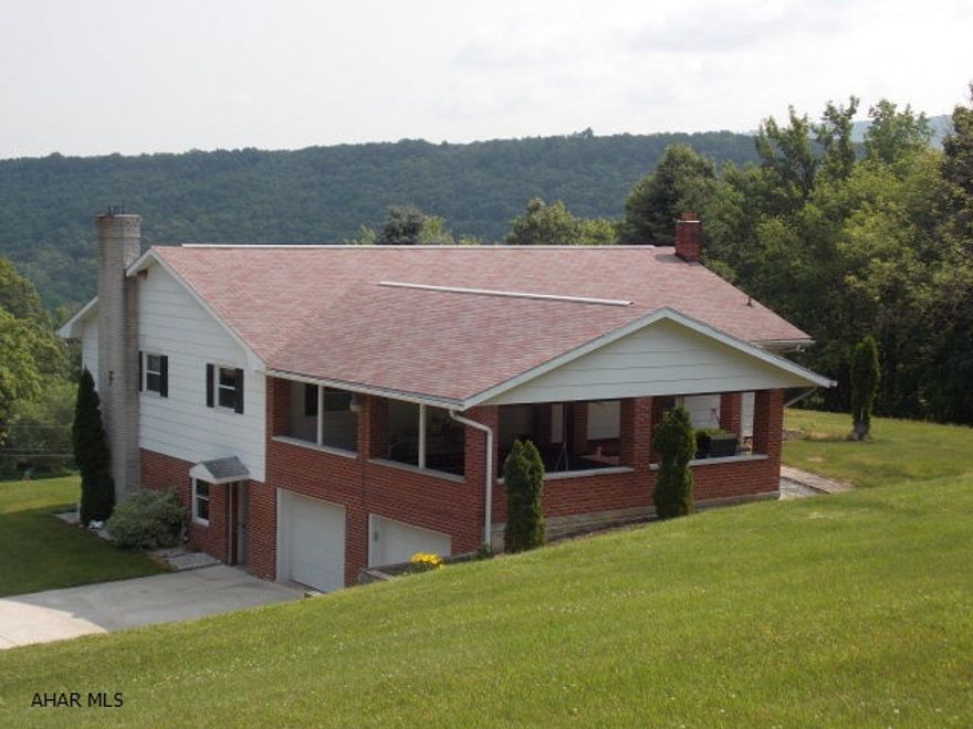 So much space for entertaining inside and out. The kitchen and living room are large and open to a covered patio in the back and a large porch in the front. 3 Bedrooms and 2 baths on main floor. Downstairs is a huge walk out basement with kitchen, family room with a fireplace, a 3/4 bathroom and an office. Great views, privacy all on 5.9 acres.