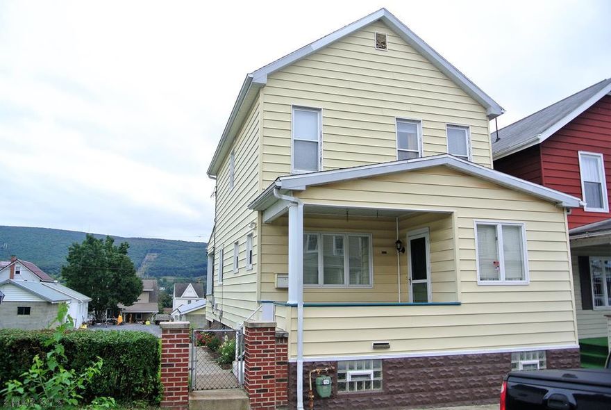 Fantastic Starter home in a great neighbor centrally located to everything.  Its low maintenance, great mechanics, and extra features make this home an exceptional value.  Enjoy your huge yard with its double lot, the extra space for your vehicles with its large off street parking area and 1.5 car Garage,and the Great Views of the mountains from your rear coverd porch!!    You also have the benefit of 1st floor laundry, Central A/C, Vinyl siding, spacious rooms, a walk out basement, and a Cherry kitchen fully equipped with appliances.  Wow!!! How many homes in this price range offer this much!