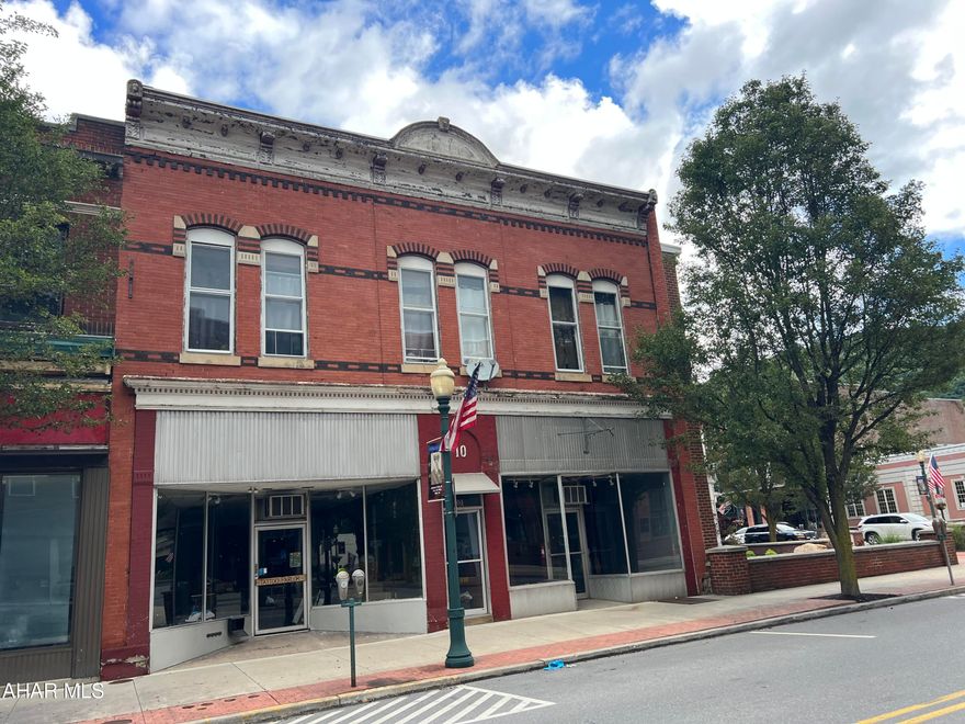 Attention business owners and investors! We are pleased to offer this commercial building in downtown Tyrone. Building consists of two commercial storefronts (that could be combined into one) and a residential single family apartment for additional cash flow. This location has both a high foot and vehicle traffic count. Apartment is rented for $725 per month on a month-to-month lease. The two commercial spaces will be available in October for $650 (8 W 10th St) and $1100 (10 W 10th St). Now is your chance to participate in the revitalization of downtown Tyrone at a great CAP rate.