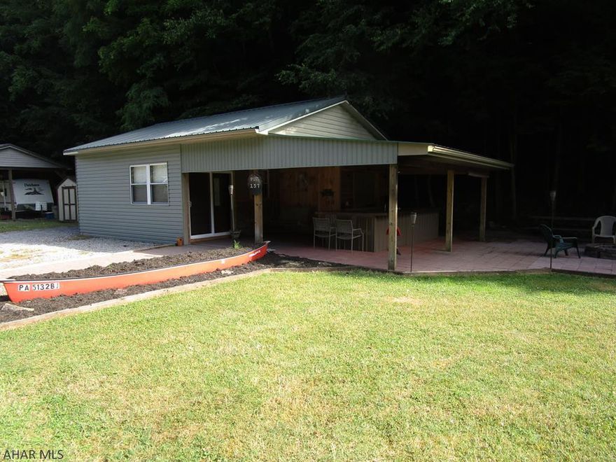 Camping with room for the whole family OR the tiny space you have been looking for to live in full time.  Remodeled camper with addition feels like a cabin.  Extra large back bedroom with adjoining bunk room along with the loft bedroom means sleeping for up to ten people.  Bath with tiled shower brings the comfort of home.  40 gallon water heater so everyone gets a warm shower.  Full size refrigerator to feed a crowd.  Sit around the fire pit next to the privacy of the woods behind you.  Outside bar with range inset  allows you to cook in the fresh air which is what camping is all about.  Many extras.  Seller will consider financing up to half of the asking price.