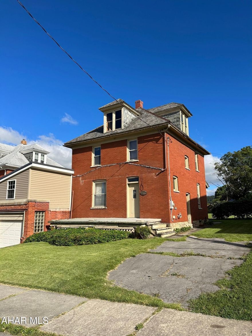There is more than meets the eye with this two-story, well built brick house along a quiet street in the beautiful town of Roaring Spring! Looking for a buyer who loves DIY projects and will appreciate this house's history and design.
The house has 2 driveways and a 2-car garage directly off Rockingham Avenue. A nice backyard for kids to play, has a grape arbor and a concrete pad along the back alley to hold a storage shed.
Modern open kitchen has lots of storage space including a Lazy Susan. The dining room holds a unique, built-in oak China cabinet and a fold-down countertop for extra space when entertaining.
Adjacent to the dining room,  a small oak staircase leads to a large room above the garage. The insulated room has lighting, electric heating and plumbing ready for you to convert into a large walk-in closet, extra bath, and master bedroom.
The living room is open design and has a built-in coat closet.
The beautifully restored original oak staircase and baseboard leads to 3 bedrooms with closets and a bathroom upstairs. The bathroom has a shower with corner seat and anti-skid flooring. One bedroom is finished with carpeting and 2 bedrooms have original hardwood floors that can be finished to your liking.
The house has a large attic and basement with a fruit cellar.
With some updates to the exterior, you could turn this house into a wonderful home for you and your family. Take a tour and see for yourself!
Please see roofing estimate included in documents.