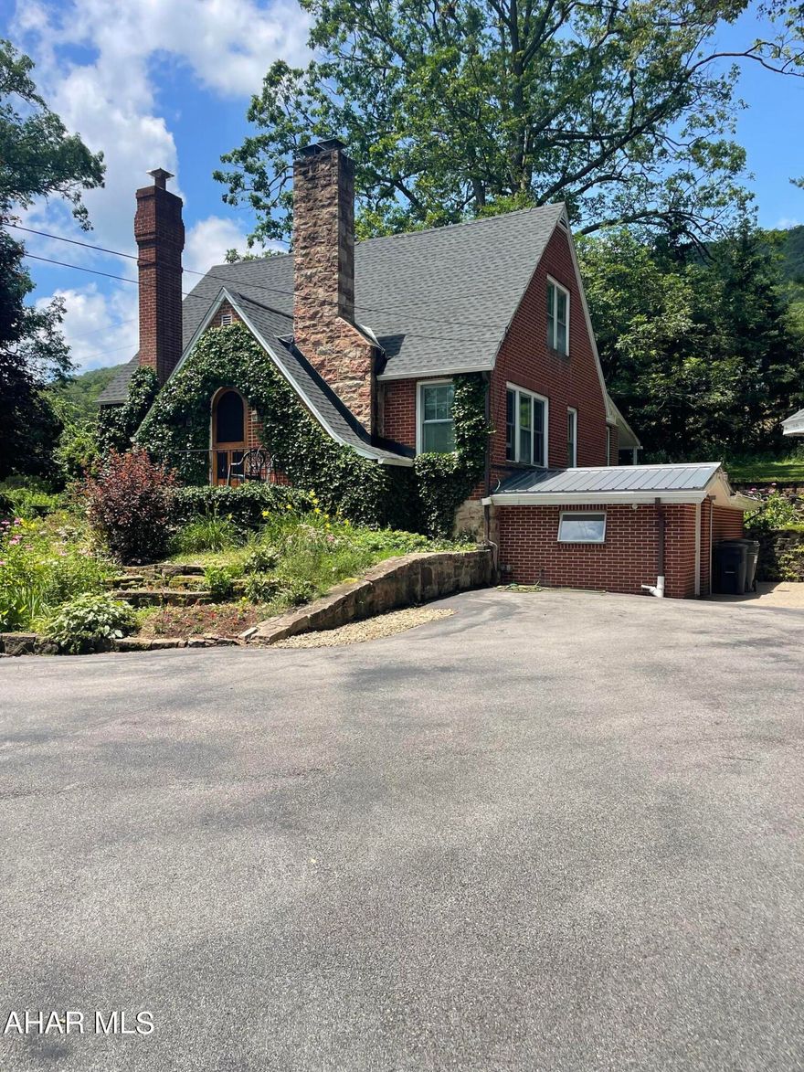 This one was plucked straight out of a storybook! The definition of privacy is right here. Situated near the center of 1.8 acres, this 3 bedroom, 3 bath, well-kept home is ready for a new owner. Upon entry, step into the living room and cozy up to enjoy the stunning hand-cut, stone fireplace. From the living room is the office/library, which can easily be transformed into a main-floor bedroom and walk-in closet. Upstairs contains a full bathroom, spacious second bedroom and master suite, complete with a walk-in shower which then wraps around to a walk-in closet! Opposite the living room features the intimate, formal dining room, leading into the kitchen, containing paper-stone countertops and uniquely tiled backsplash adding character and charm to the heart of this home. A casual dining space stems beyond the kitchen, leading to the three-season, sunroom- perfect for enjoying the tranquility of country living. The casual dining area also leads to a full bath and to the basement where you will find a family room, laundry room and workshop/mudroom with walk to easy access to the detached garage! The detached, 2 car garage contains an upper level ideal for storage, there is an additional 1 ½-2 car garage attached to the rear of the garage for additional storage. Call to schedule a private tour today to start your own fairytale in picturesque Sinking Valley.