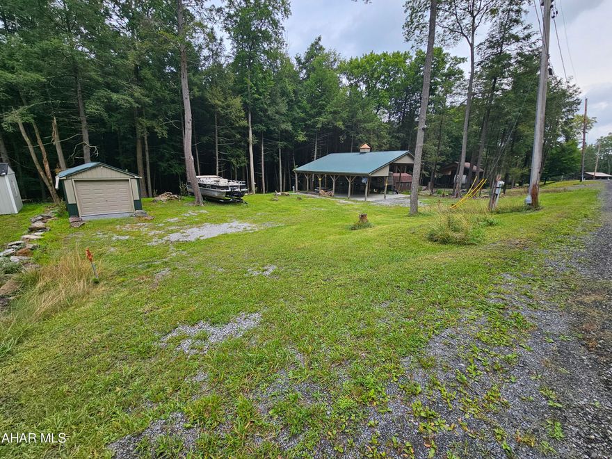 2 vacant campsite lots in Glendale Yearound. 
Main lot has a beautiful, spacious pavilion to protect your camper and also accommodate outdoor activities. 2nd lot gives you extra space for parking or storage. These are nice level lots with undisturbed woods behind them. Camper and shed are NOT included.