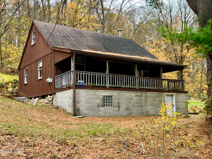Escape to nature with this cabin nestled on nearly 2.5 acres, bordered on three sides by PA State Game Lands 261 consisting of 3,220 Acres. Perfect for hunting, fishing, boating, and hiking, this property offers an ideal retreat just 20 minutes from Lake Raystown and minutes from the Juniata River and H&BT trails. The cabin features a main-floor bedroom and a spacious loft area to comfortably sleep all your guests. It includes a 3/4 bathroom, living room, kitchen, and a covered front porch perfect for relaxing and enjoying the outdoors.