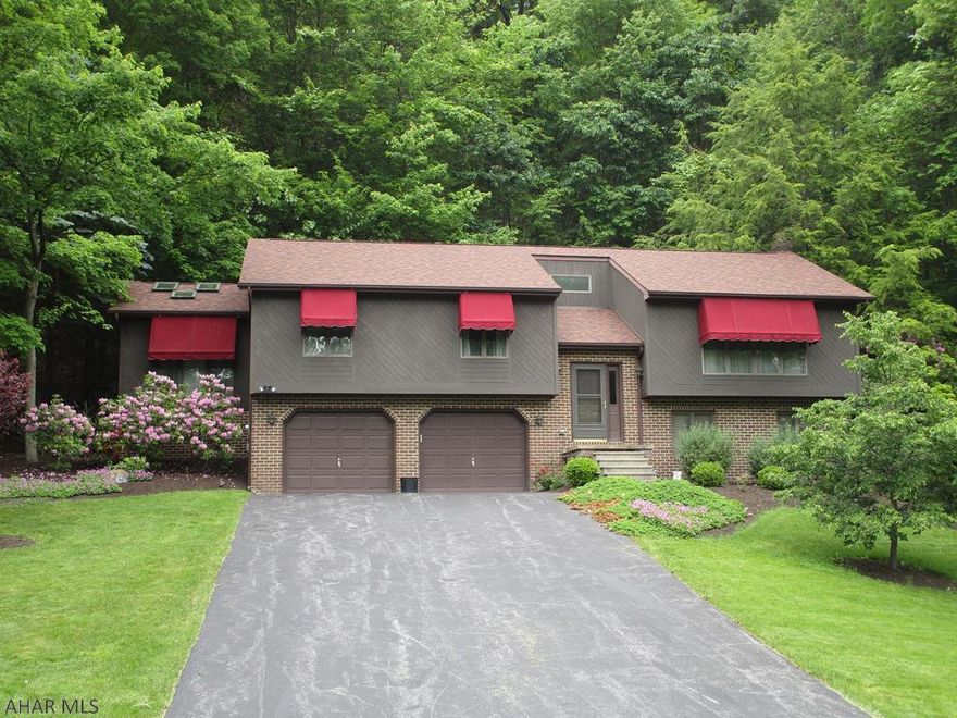 Beverly Hills. 3 bedroom, brick & cedar. 2 1/2 baths. Den or office off of the master bedroom that has 6 sky lights. Screened in porch off of the dining room. Eat in cherry kitchen with panty.  Family room with a wood stove ( never used) 2 car garage. Professionally landscape. Central air. 2 lots are included. .82 & .81  House is .81.(201 x 151 irr) Vacant lot is .82 (142 x 257 irr) Total lot is 1.63 of an acre. Sec. system