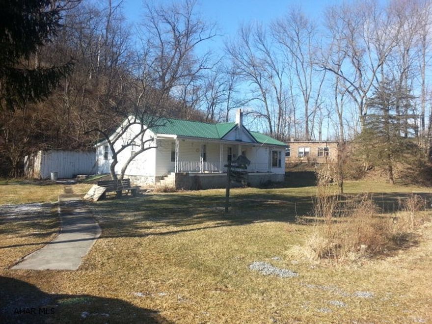 Ranch home with frontage on Clover Creek for excellent trout fishing. Building behind house is used for storage.