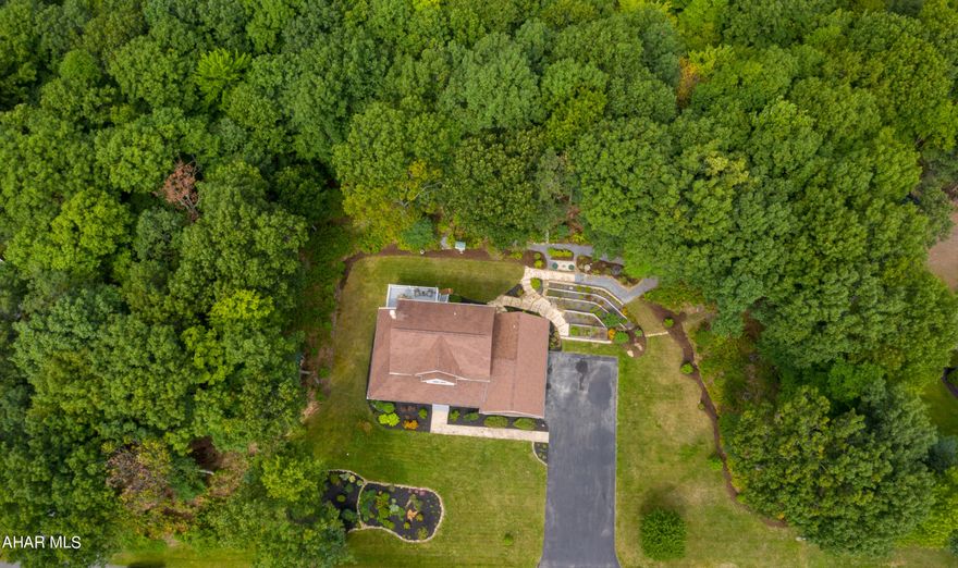 Impeccable 2 story home situated perfectly on almost 2 acres in Laurel Heights just minutes away from I-99. Featuring 3 bedrooms and 2.5 baths, this gem will be sure to check off all of your boxes! Upon entering the front door you will find original hardwood flooring that is meticulously kept throughout the first floor. Beautiful French doors separate the dining room and kitchen.  The kitchen is open to the living room and offers stainless steel appliances, quartz counter tops, tile backsplash and plenty of natural sunlight with sliding glass doors that open to the back deck.  First floor laundry room, a half bathroom, and a spacious mud room with a large closet completes the first floor and makes a great space for extra storage or even workout equipment! The master suite offers a walk in closet, and master bathroom with a double vanity.   The partially finished lower level makes a great space for entertaining or recreation room. Easily add a lower level full bathroom with rough in plumbing already done, the possibilities are endless! Spend evenings relaxing on the wrap around porch or on the patio outback!