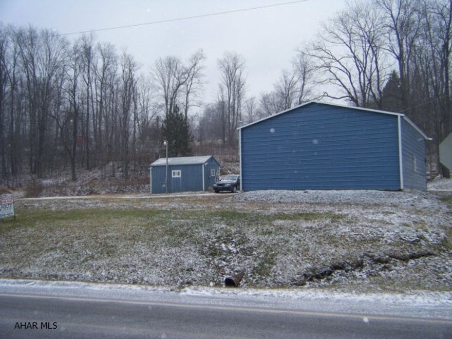 Garage on 1.4 acres. Subdivision approved. Public water and sewer is available but not hooked up.