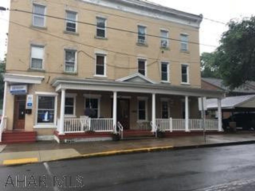 Formerly the Williamsburg Hotel - so much history!  In the heart of Williamsburg is this 7 unit building with 2 commercial tenants and 5 residentials.  Excellent rental history.  Owner pays heat, water, sewer and trash.  Tenants pay their own electric.  Hair salon has electric heat.  Tenants pay for her electric.