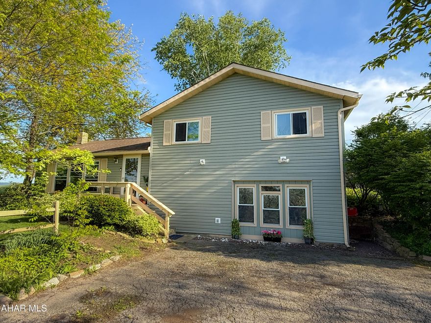 Lovely Multi level home on .688 of an acre offering surrounding mountain views! Spacious living room with finished wood floors. Open Eat-in country kitchen with painted cabinetry and stainless appliances and a coffee bar! Off the kitchen is new wooden deck, beautifully landscaped with a privacy fence. Nice family/bonus room with easy access laundry offering plenty of storage throughout the home. There is a room to add a bathroom and plumb ready to go. The heat source is ready to be converted over to oil heat, ''furnace is not provided '' and registers and oil tanks are in place. Wood stove and Radiant heat. Located off Rt 220 N, I-99 and I-76 turnpike and minutes from town. Radon Mitigation system is installed.