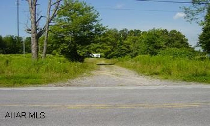 6 flat Acres with frontage on Coupon Gallatzin Road.  Mixture of field and woods.  Older well and septic unknown functionality of either,  testing at buyers expense.  Shed on property will stay as well as older mobile home as is, two campers to be removed.  Electric on site.  Gas, oil and mineral rights DO NOT transfer.