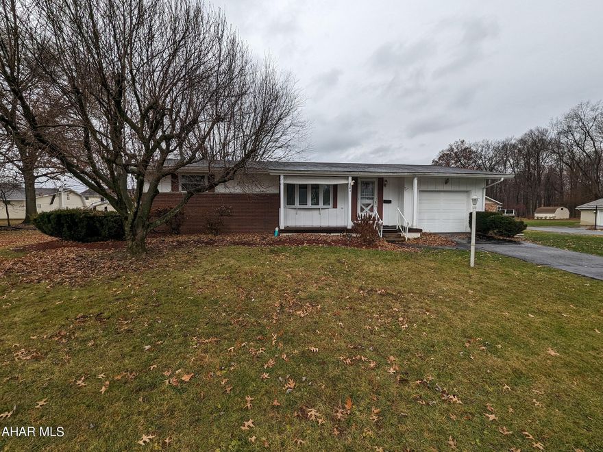 Hollidaysburg area 1 story home features one floor living! Nice neighborhood in Fort Fetter area w/ large, level lot. Spacious living room with ornamental FP, eat-in kitchen w/ Corian counters, 3 bedrooms, 1 bath. One bedroom has been converted to a laundry room, but could easily be converted back into a bedroom. Finished basement w/ FR and bar plus utility/laundry area. Screened back patio, front covered porch, 1 car attached garage w/ openers and ramp (not ADA compliant - could easily be removed). Insulated glass windows, storage shed and central air. Better check it out!