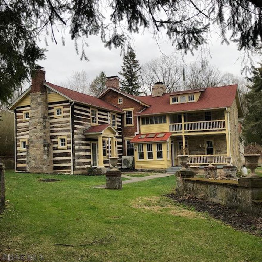 Welcome to the historic 'Lutz Mansion' resting on 4.9 acres above the R.B. of the Juniata River. This 1800's old-world charmer remains tastefully true to the era's style with beautiful wood floors, six working fireplaces in main house and two in the museum house, four porches with views of the river, two cozy solariums, formal living room, large dining room, fabulously updated kitchen w/soapstone and maple counters, inset cabinetry and original stone fireplace.  Three large bedrooms in the main house w/ensuite bathrooms and library w/private entrance that could be a fifth bedroom. Log house w/private entrance, kitchen, living room, bedroom and full bath. Stone-work landscaping-pillars-small pond-garages-outbuildings, island & more on this park-like acreage. View the virtual open house.