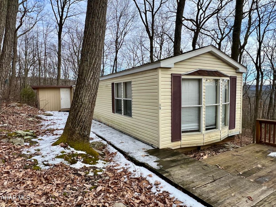 3+/- Wooded acres with a mobile home and electric.  Would make a great location for a camp or getaway. Located minutes from Buchanan State Forest and Pike 2 Bike. Property is being sold AS-IS and does not have a well or septic system, will need to be a cash sale only.