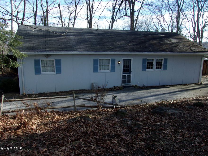 Nestled in the trees, this 2 bedroom beauty on over 2 acres, is close to town, but OH, SO, PRIVATE!!!  Wood floors throughout.  Large sunroom boasts wonderful views.  Mostly wooded and some open area with a small workshop/gardening shed on site.  This can be full-time living or the perfect weekend getaway. You'll want to come and see this!!!