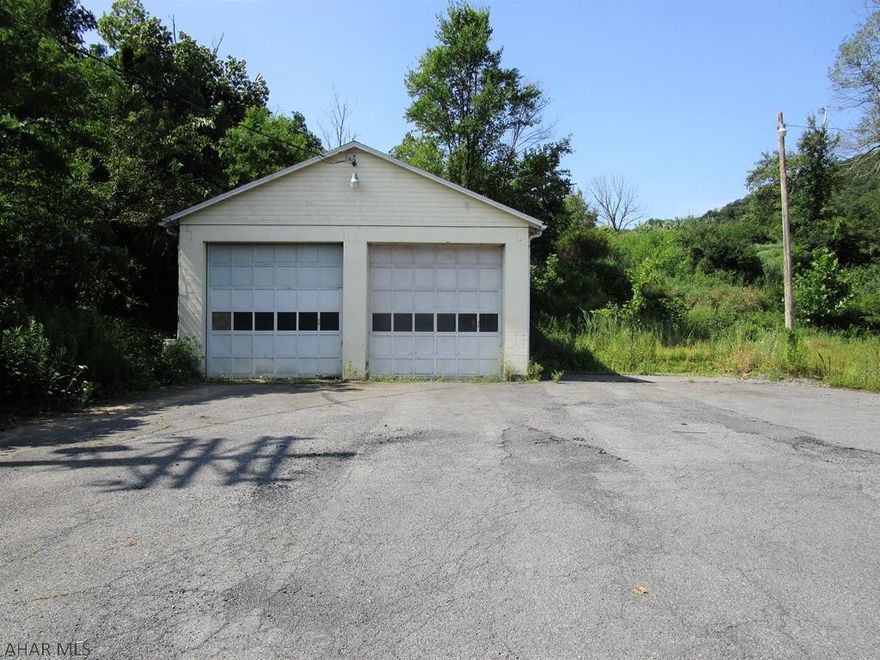 Looking for a garage close to town? This is it!! This property offers a 900 square foot garage with 12' overhead doors, 13' interior ceilings and a concrete floor.  Large level lot containing .609 of an acre.  Perfect for a repair garage, hobby garage, additional car-storage, boat storage, or other uses. No water or sewer on site but electric is present.