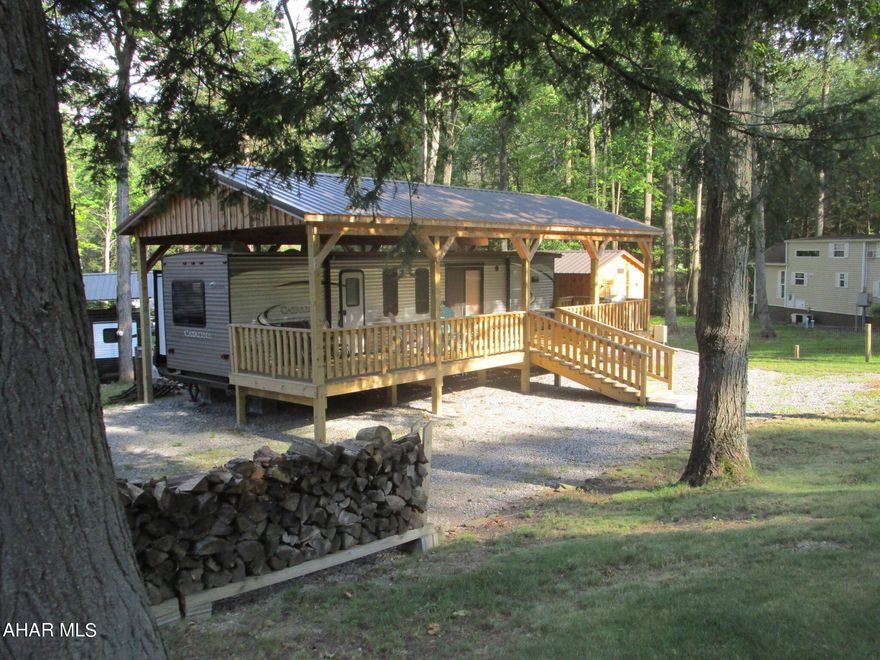 Glamping:  glamorous camping starts here.  Two bedroom camper with lots of extras.  Add to that the expansive covered deck and fenced yard which offer peace knowing the little ones (children and/ or pets) can safely run free.  Large new shed.  
Located in Glendale Yearound and adjacent to Prince Gallitzin State Park / Glendale Lake.  This is a must see!