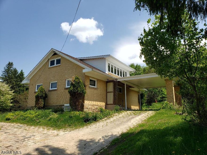 4-bedroom brick home with large detached garage.