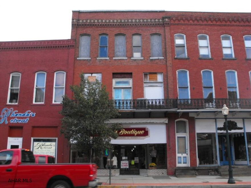 3 story brick commercial building with 2600 sq ft store front on 1st floor.  2nd & 3rd floors have tons of potential.  Newer gas fha heat with central air on 1st floor. Rubber roof 2005.