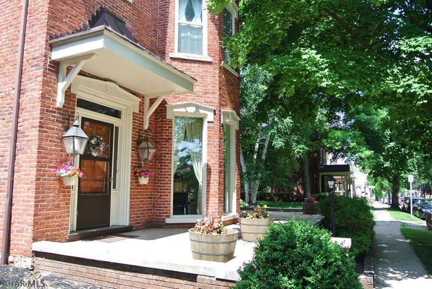 This 5 bedroom 3.5 bath 'Extraordinary' classic blends its beautiful time-honored interior architecture with many tasteful charming modern updates.  See how this 19th century character with the10ft ceilings, 9in baseboards, elegant crown mouldings, exposed brick, and vintage light fixtures intertwines with its newly custom built  540 sq ft. kitchen, stainless steel appliances, stylish sink fixtures, recessed lighting. center work station, and a massive 26 feet of solid surface countertop. This 'HISTORIC' home also sets on one of the largest residential lot in town, Hollidaysburg.   This 1/2 acre lot is beautifully landscaped with an attached cover pavillion for summer entertaining, a 2 car garage, and a unique wrap around open patio all the way to the front door.   You have to see it!