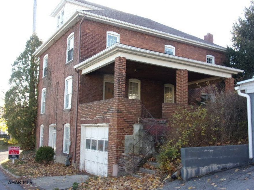 Live in one, rent the other!  Large, well-built 2-unit brick on a corner lot.  First floor unit has 3BR's, 1BA and great side porch.  Second floor has 2 or 3BR's with laundry room.  One-car integral garage.  Spacious units with hardwood floors on both floors. So much potential on this one!  Storage shed included.