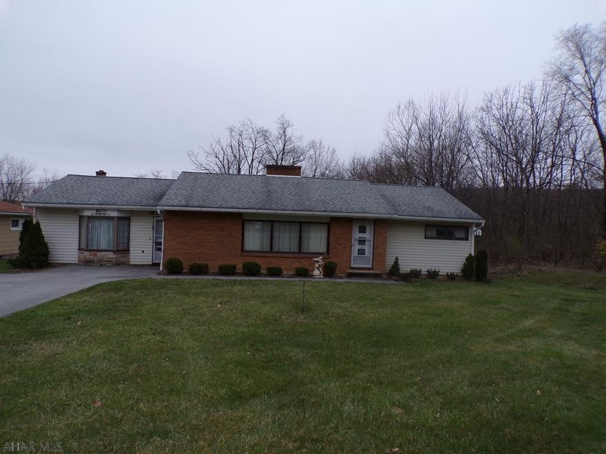 This home needs some updating but it is in one of Altoona's most desirable neighborhoods and it  sits on almost a half acre!!  Beautiful hardwood floors throughout.  There is a fireplace in the living room and a wood burner in the family room.  The basement has a walkout to the large yard and also has a fireplace.  All the bedrooms are nice size and have very large closets.  The sunroom just off the living room gives you a beautiful view.