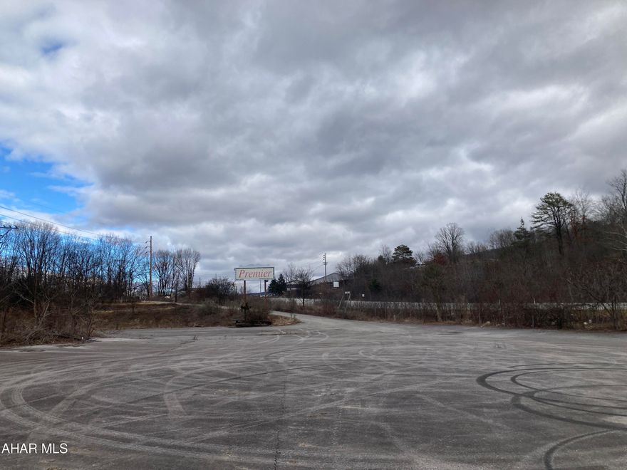Lot is mostly cleared and level.   There is asphalt paving from previous use as car lot.  Approximately 620 feet of frontage along the west side of E. Pleasant Valley Blvd.   Good access to I-99 being less than half a mile from on/off ramps.  No zoning affords many possibilities for use.  Residential,  commercial,  industrial.