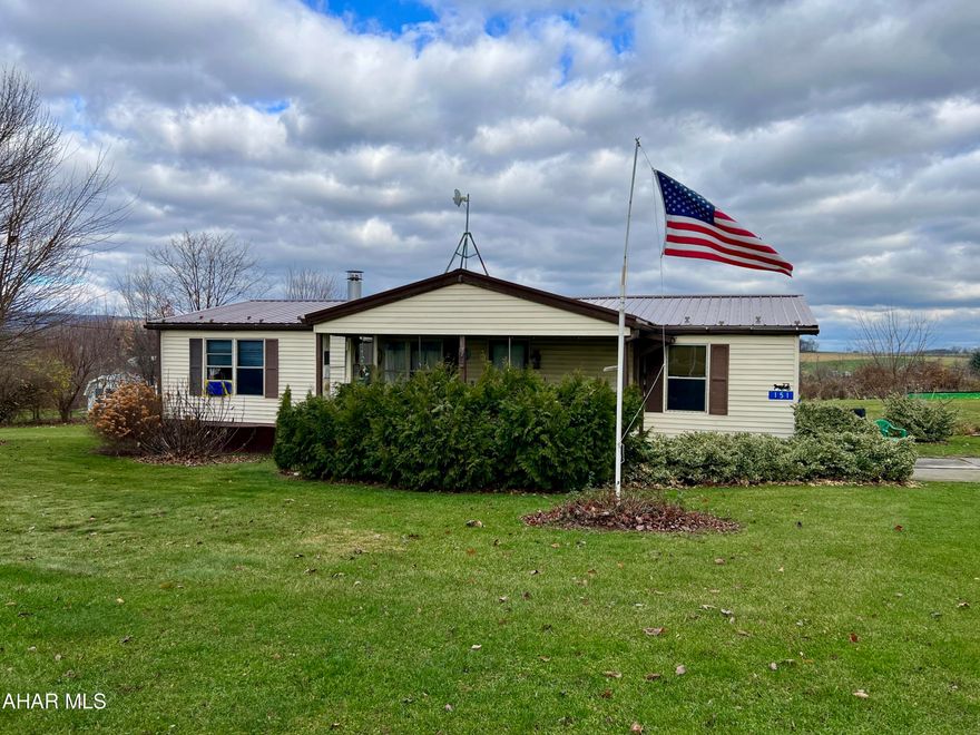 Manufactured home located outside of town offering great views of the countryside. The home features 3 bedrooms, 2 baths, living room with fire-place, eat-in kitchen, & laundry. Outside, you will find a covered porch, new metal roof (2024), detached 1 car garage, large yard, and raised garden beds.