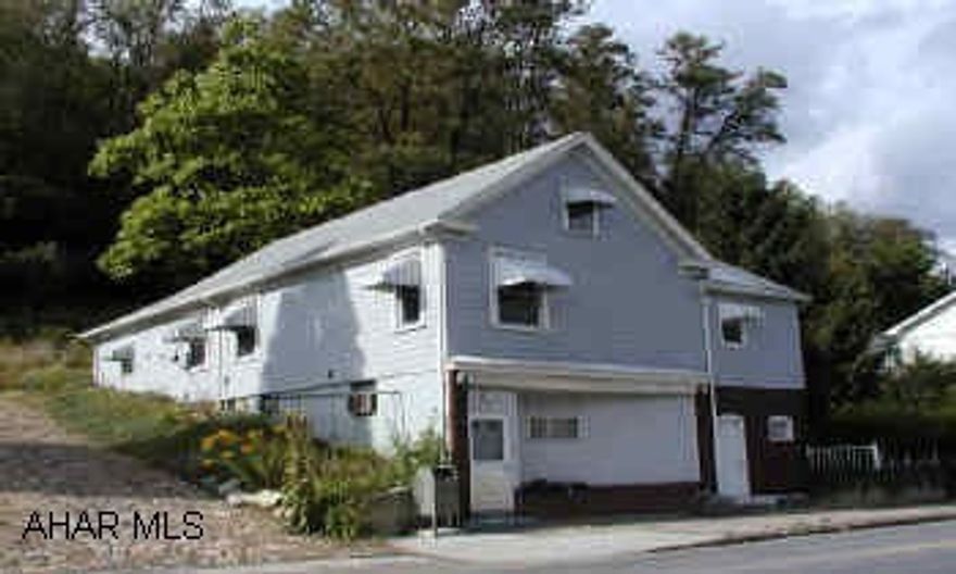 Hardwood floors in living room, dining room and bedroom.  Gas fireplace in living room.  Basement is partially finished with 2 rooms kitchen and bath.  Main bathroom is remodeled. Property has been used as 2 apartments or one apartment with a studio.  Modern kitchens on each floor.  Range, refrigerator, and dishwasher.