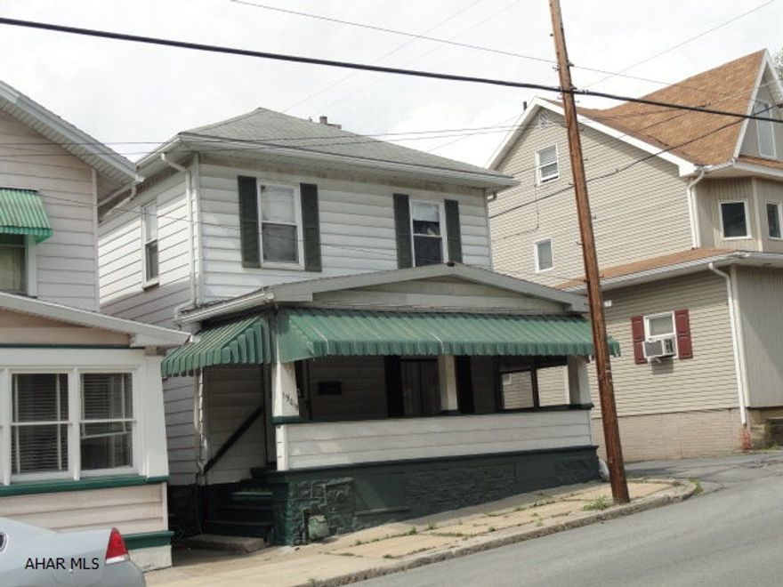 Hidden Gem: Two story 3 bedroom, 1 bath near Altoona Hospital and Altoona Campus. Move in ready. Large living room and dining room (hardwood under newer carpeting) Kitchen with newer cabinets, refrigerator and range hood. 3 large bedrooms; each with walk-in closets. Loads of storage through-out. Walk-up attic with blown in insulation. Central air, newer roof, new second floor windows, newly painted, small fenced yard, large front porch. A must see. Silent Giant waiting for an owner.