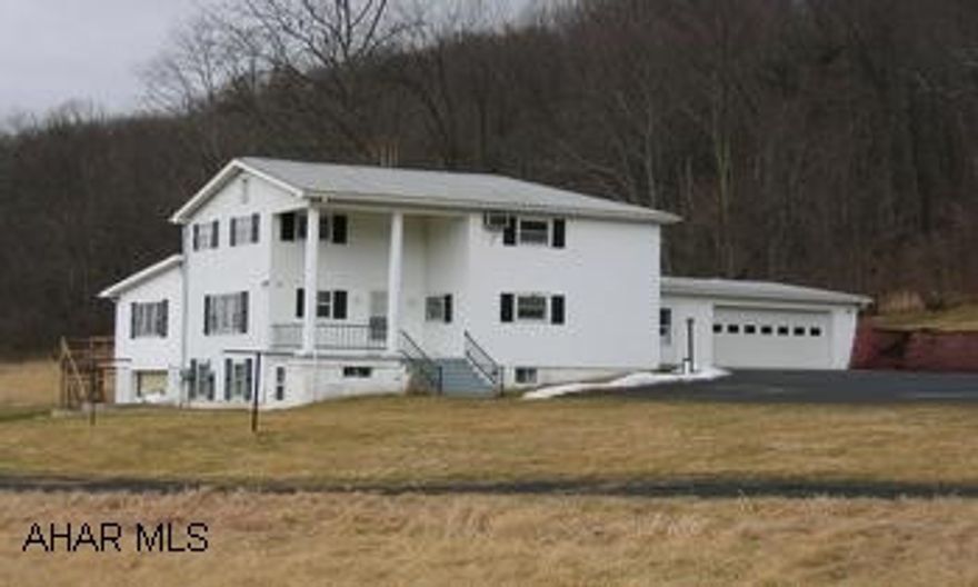 2-story restored farmhouse on 21 acres, mixed w/fields and woods. 3BR/1 full 1 3/4BA, country kitchen opens up to a large family room. Attached garage and 1-car intregal garage. Even more privacy in the Spring time when the leaves come on. Plenty of wildlife, deer, turkeys, you name it! Electric heat; baseboard and ceiling. Propane fireplace in the family room.  Deck with view, great for cook outs.