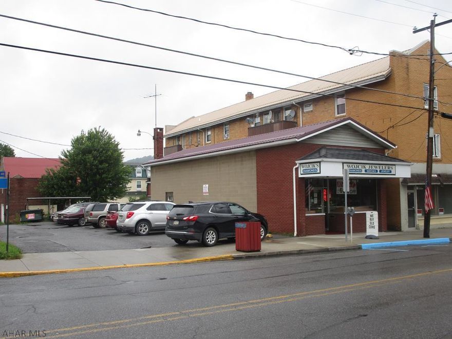 Quality constructed one story commercial building used as a jewelry store but could lend itself to other commercial uses. Would make a great office or retail store. Block construction with brick front. Newer metal roof. Clean and well maintained. Street parking and side paved parking for 6 cars. Interior has a showroom, office room, storage room and half bath. Security system included. Fa oil and central air. Great building for a good price. Real estate only being sold.