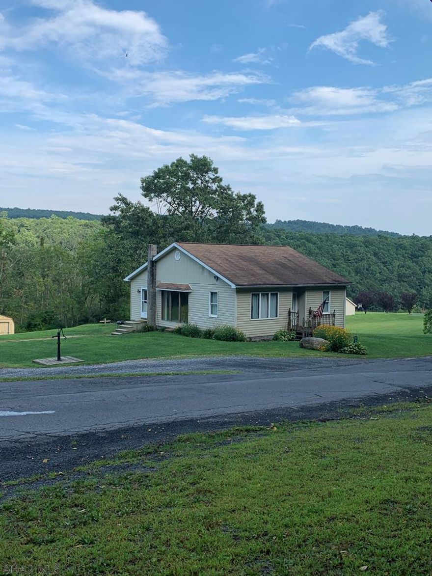 One story ranch on 4 acres with beautiful views. Home offers three bedrooms, master with a walk-in closet, one bath and a full attic and unfinished basement. Pavilion with electric, garage foundation unfinished, and a 20 x 16 bomb shelter. This property is a must see!
