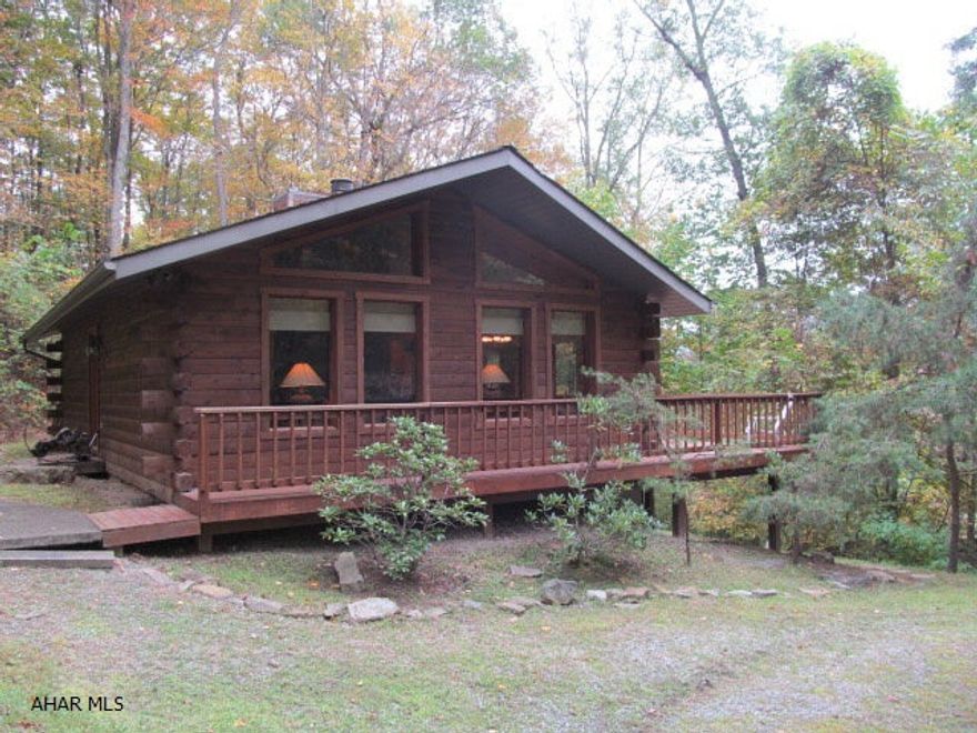 Boating season is here!  Are you looking for a private retreat near the lake, less than 5 mins from Shy Beaver boat launch?  Then you will love this log home with lots of windows to enjoy the wooded scenery.  Open concept floor plan and a floor-to-ceiling stone fireplace make this a warm and inviting home.  Full finished lower level and wrap around deck. Some of the furniture stays and this is ready to move in to.