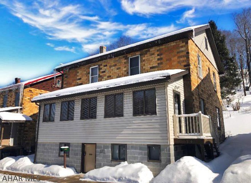 Blacklick Valley schools. 2 story brick & vinyl sided home with 4-5 bedrooms in Nanty Glo. 1st flr. has a living room, dining room, kitchen, laundry room, sunroom w/gas fireplace & an enclosed back porch. 2nd floor has 4 bedrooms with plenty of closets.  bathroom in the basement. Pull down attic. All appliances included. Extra toilet on 1st flr. 200 amp breakers. Mostly newer windows. Low taxes! Call for your appointment today!!