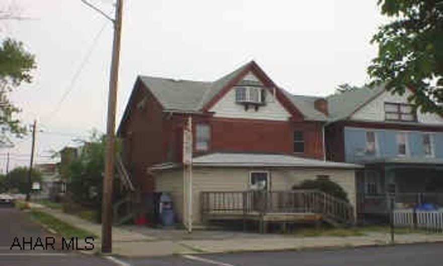 Brick corner store or office with 2 apartments overhead, separate electric, apartments in good condition.