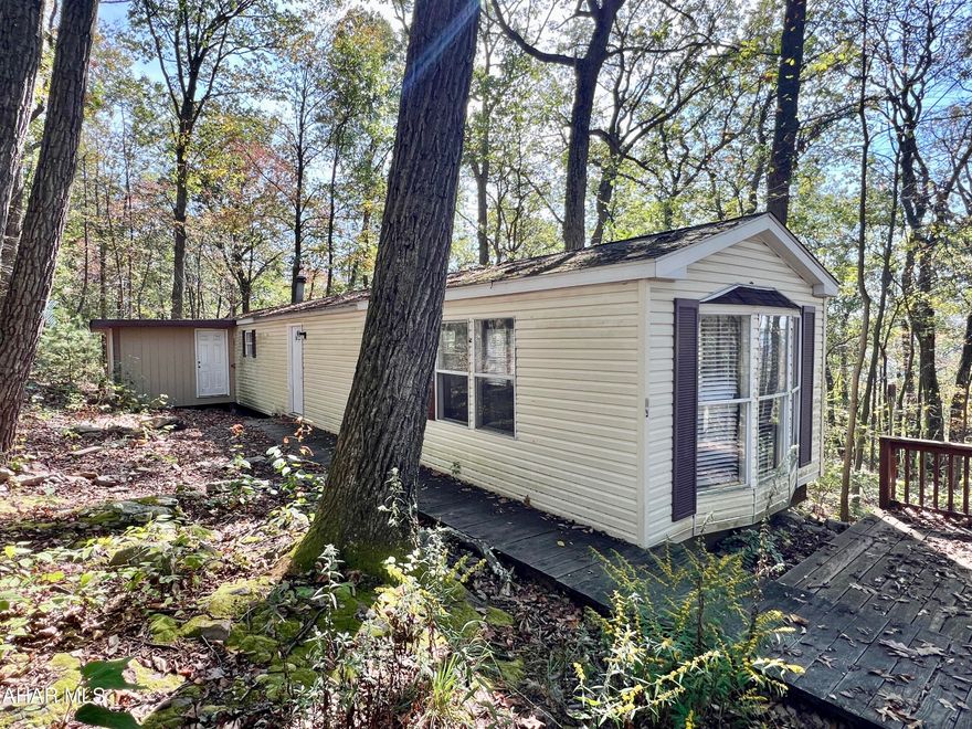 3+/- Wooded acres with a mobile home and electric. Would make a great location for a camp or getaway. Located minutes from Buchanan State Forest and Pike 2 Bike. Property is being sold AS-IS and does not have a well or septic system, will need to be a cash sale only.