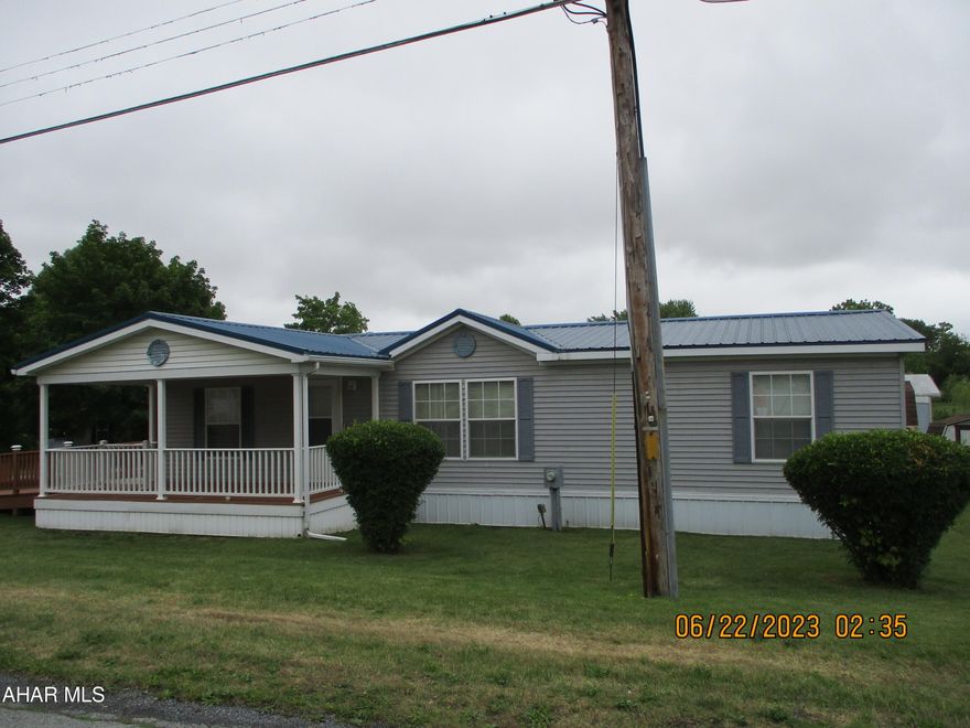 Well cared for double wide on rented lot features covered porch, handicap access ramp, open  living area.  Large kitchen with all appliances. built in entertainment center in living area.  Nice sized bedrooms, off street parking.  Some new plumbing in 2022. Monthly rent is $405 and includes trash.  Buyer must be approved for lease.