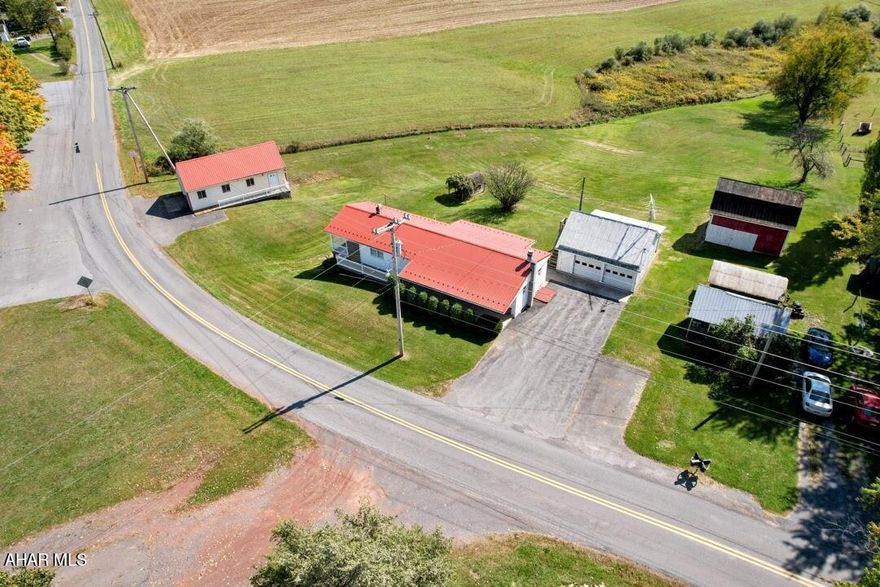 Looking for a property with loads of garage space? This one has it along with everything you need to feel right at home. Relax by the wood burning fireplace in the living room or sit on one of the many decks and enjoy the views of the surrounding countryside. The full basement features a large family room with woodstove, easy walkout to back yard, additional rooms for storage & laundry with a convenient bathroom area with shower. Two detached garages have a combined five bays and both have heat and electric. The barn is another bonus area to tinker or store your toys. This is a nice property at a terrific price. Call to schedule your tour.