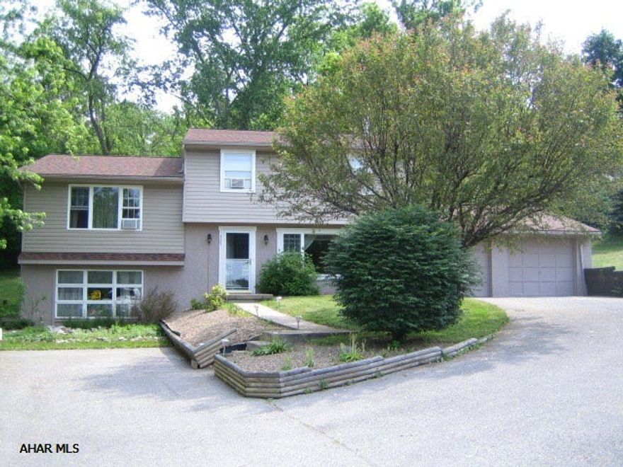 You will feel at home! 323 Aggie St, Frankstown Township, Hollidaysburg.  Multi-level, 3-4 bedrooms, 1.5 bathrooms, eat-in-kitchen with center island and HW floors, formal dining room with HW floors, living room with wood-burning stove, family room or 4th bedroom, den/office, laundry, rear sunroom with tile floor to patio, 2-car attached garage, shed, ample storage.  Carpet has been replaced on lower two levels and home has been freshly painted throughout.  Beautiful setting!