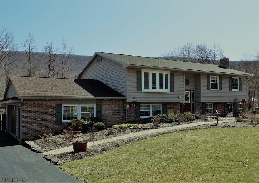 Lovely, bilevel with many custom finishes, including Cabinetree cherry kitchen, SS appliances,  large full bath with custom tilework and large walk-in shower and heated floors.    Family room with wet bar and wood burner insert fireplace,. 18' x 36' heated inground pool and fenced patio area.  Pool shed.  Large rear deck accessible from DR and lower paved patio area.  3-season room has wet bar, built-in stereo system and TV.  All situated on a level, landscaped .85 acre lot in Frankstown Township.  3 heating sources; 2 heat pumps and electric baseboard heat.  You've got to see this one to appreciate all the extras, and tasteful decor!   Some furnishings may be available, seller is downsizing.  Great place to spend your summer - everything you need is right here!