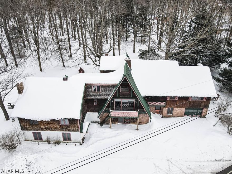 If you have ever dreamed of owning a ski chalet or mountain top home on one of the highest mountains in Pennsylvania, this may be a dream come true.  The Blue Knob All Seasons Resort is located within a couple of miles of this home and is the highest altitude resort in Pennsylvania.  With some work and imagination, this A frame sitting on 4.042 acres has incredible potential.  There is plenty of room to operate a business or home office.  Imagine having a property with 3 fireplaces, exposed brick and wood for an incredibly low price for someone to make their own.  An adjacent lot is also available for sale.