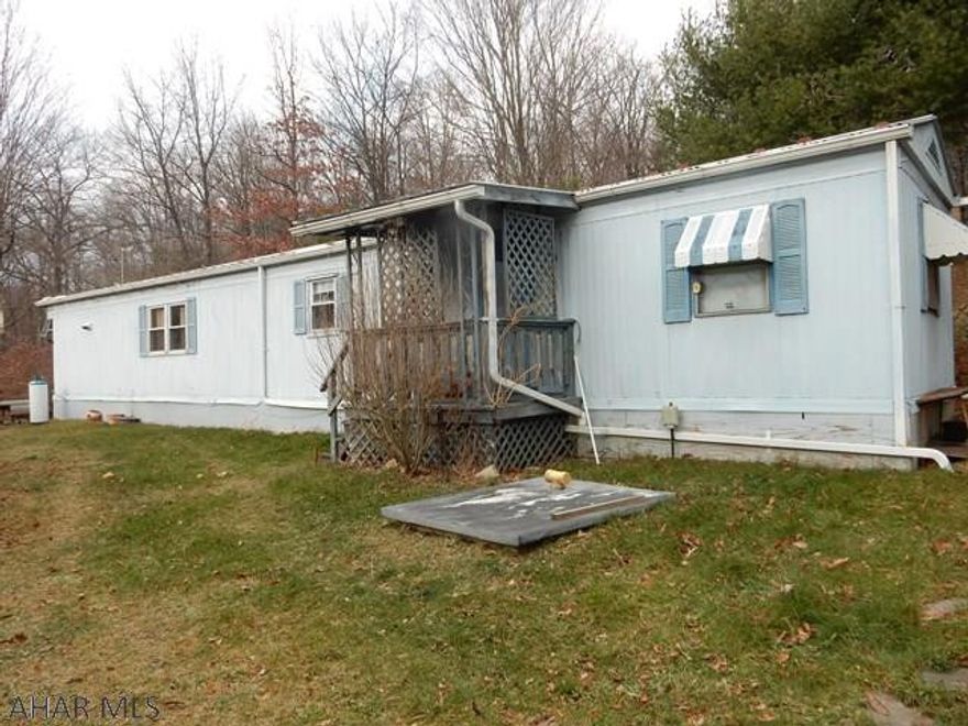 Would you like privacy or a get away place in the woods ? Are you in need of a hunting retreat?  Enjoy this serenity, supplied by nature.  Tons of beautiful perennials (roses, daffodils, tulips, forsythia, lilacs, burning bush) and fruit bearing trees. Pear, apple, cherry, grapes, 2 gardens, a chicken coop and a smoke house, all surround this home.  There are deer here every day and even an occasional friendly bear, visitor.  This home is well insulated and cozy.  There has been a new well installed within the past 2 years.  The outdoor furnace could be used with wood or coal. Electric and heat are in the shed. Privacy abounds here and has a terrific view.  ENJOY !!  Home warranty included for 1 year.