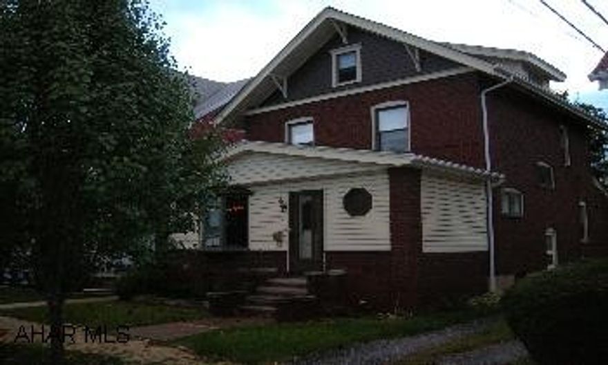 Beautiful 2 story brick with 3 bedrooms and finished attic.  This home has all natural golden oak trim, hardwood floors, enclosed front porch, new roof, updated windows, fenced yard, and 2 car detached garage.